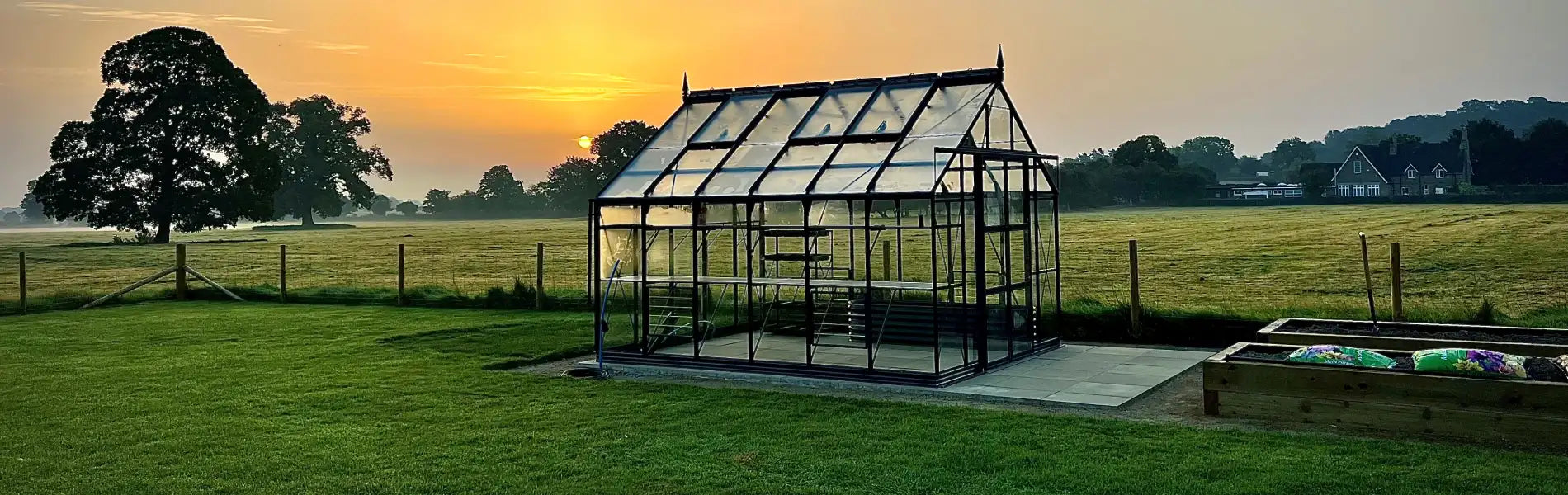 Sun setting behind a Rhino greenhouse