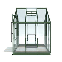 Rhino Greenhouse with a triangular roof and transparent glass panels stands on a paved platform. It features a hinged door and adjustable roof vent, suitable for plant cultivation.