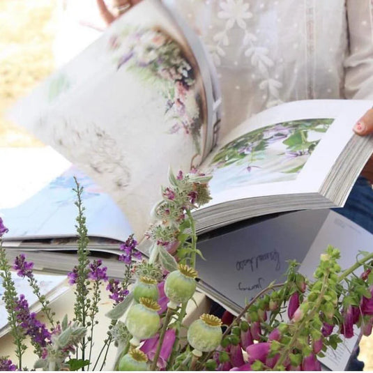 A lady flicks through a gardening book