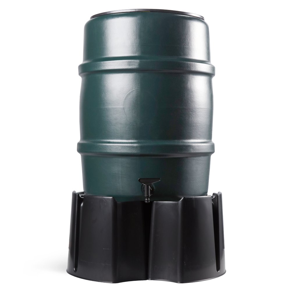 A large green rain barrel with a spigot is positioned on a black stand, set against a plain white background.