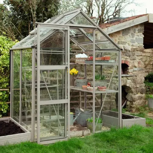 Raised Beds in clay grey next to greenhouse