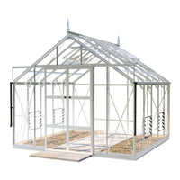 A glass Rhino Greenhouse with a pointed roof structure stands on a concrete base, featuring metal framework and side ventilation panels, set against a plain white background.