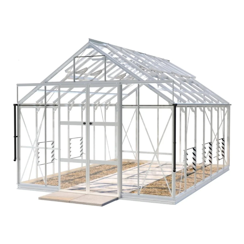 A white-framed Rhino Greenhouse with transparent panels stands on a flat, paved surface, featuring roof vents and sliding double doors for ventilation. It has a spacious interior with visible pathways.