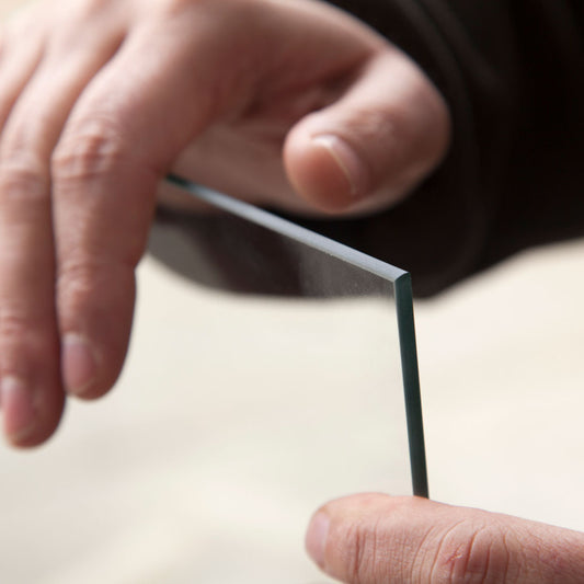 Man holding toughened safety glass pane